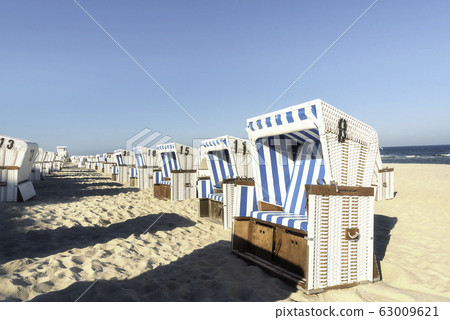 Beach chairs in a row on Sylt island. Sea beach on Beach chairs in a row on Sylt island. Sea beach on 63009621