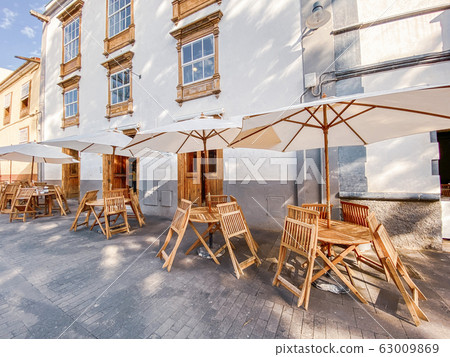 Street view with ancient houses and beautiful cafe terrace 63009869
