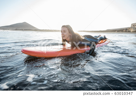 Woman swimming on the surfboard Woman swimming on the surfboard 63010347