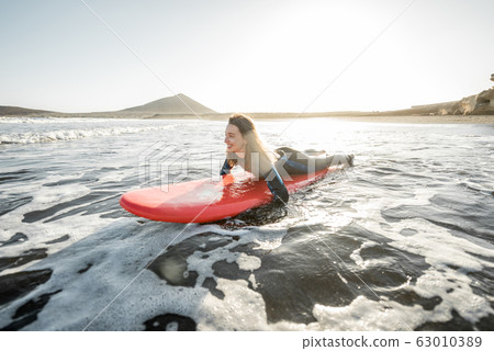 Woman swimming on the surfboard Woman swimming on the surfboard 63010389