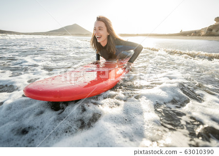 Woman swimming on the surfboard Woman swimming on the surfboard 63010390