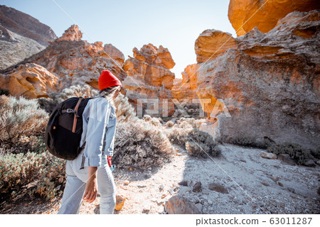 Woman traveling rocky terrain 63011287