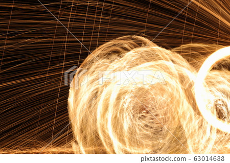 Skill Man playing fireworks by spinning wood pole 63014688