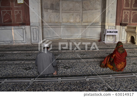 Muslim men and women praying in the prayer room at Delhi India's Mosque Jamah Masjid Muslim men and women praying in the prayer room at Delhi India's Mosque Jamah Masjid 63014917