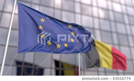 Waving flags of the EU and Belgium in front of a modern skyscraper. 3D rendering Waving flags of the EU and Belgium in front of a modern skyscraper. 3D rendering 63016774