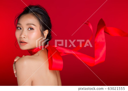 Asian tanned skin woman with strong color red lips 63021555