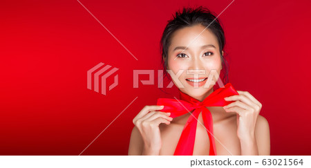 Asian tanned skin woman with strong color red lips Asian tanned skin woman with strong color red lips 63021564