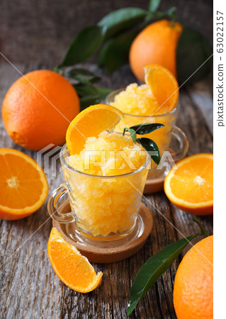Orange granita, frozen summer dessert and fresh orange fruits 63022157