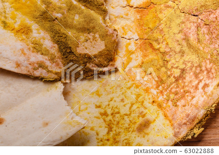 Rotten bread on table. 63022888