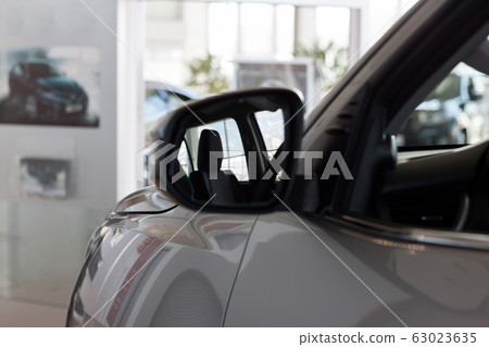 Reflection in side mirror of the new car. 63023635