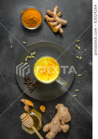 Cup of Indian golden turmeric latte milk  63024264