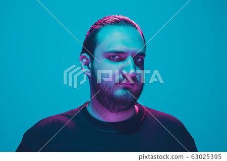 Portrait of a guy with colorful neon light on blue background - cyberpunk concept 63025395