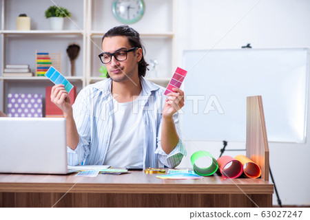 Young male designer working in the office 63027247