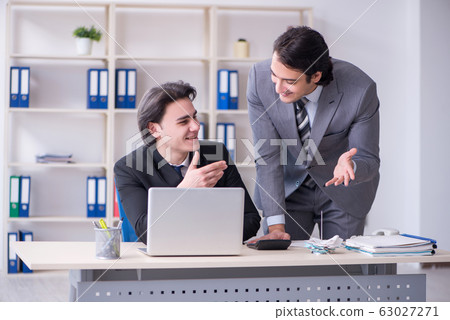 Two young employees working in the office 63027271