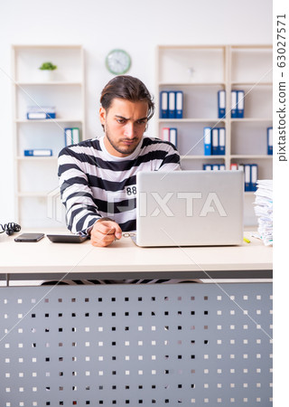Young employee feeling like prisoner at work 63027571