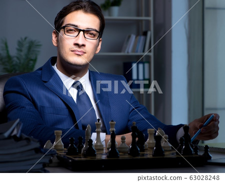Businessman playing chess in strategy concept Businessman playing chess in strategy concept 63028248