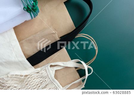 Various eco-friendly packaging on a green 63028885