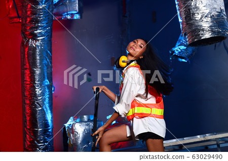 Beautiful Asian Architect Engineer woman in yellow Beautiful Asian Architect Engineer woman in yellow 63029490