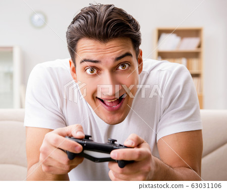 Man addicted to computer games Man addicted to computer games 63031106