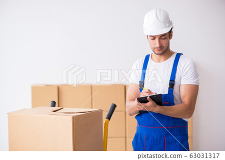 Young male professional mover doing home relocation Young male professional mover doing home relocation 63031317