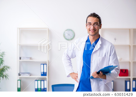 Young male doctor working in the clinic Young male doctor working in the clinic 63031429