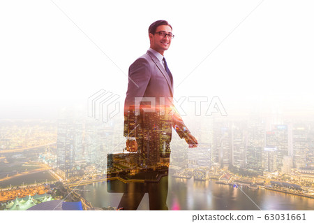 Successful businessman against cityscape in business concept Successful businessman against cityscape in business concept 63031661
