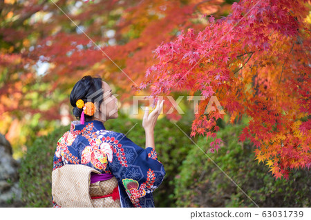 Geishas girl wearing Japanese kimono among red 63031739