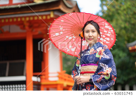 Geishas girl wearing Japanese kimono among red Geishas girl wearing Japanese kimono among red 63031745