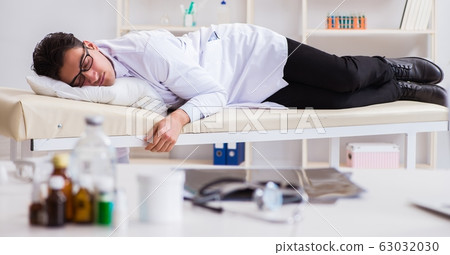 The doctor relaxing after complex surgery in hospital 63032030