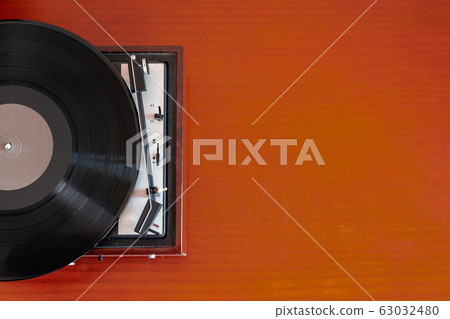 Vintage turntable made of wood on a old table Vintage turntable made of wood on a old table 63032480