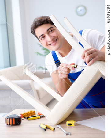 Man repairing chair in the room 63032794