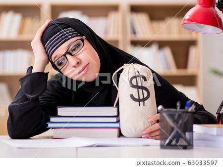 Muslim girl in hijab studying preparing for exams Muslim girl in hijab studying preparing for exams 63033597