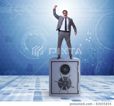 Excited businessman standing on top of safe 63035854