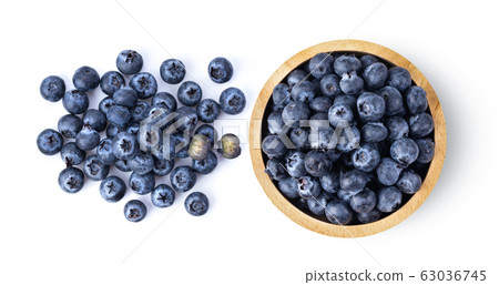 Blueberries in wood bowl isolated on white Blueberries in wood bowl isolated on white 63036745