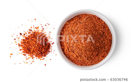 Crushed red chili pepper in white bowl on white Crushed red chili pepper in white bowl on white 63036746