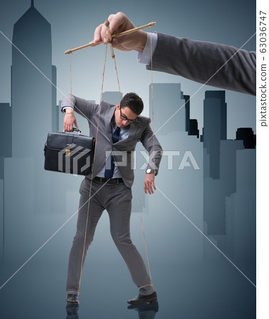 Businessman puppet being manipulated by boss Businessman puppet being manipulated by boss 63036747
