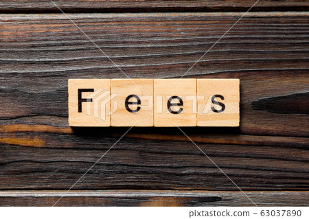 Fees word written on wood block. Fees text on 63037890