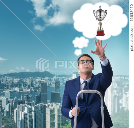 Businessman climbing towards his business goal Businessman climbing towards his business goal 63038450