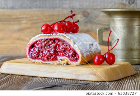 Cherry strudel on wooden background 63038727