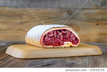 Cherry strudel on wooden background Cherry strudel on wooden background 63038729