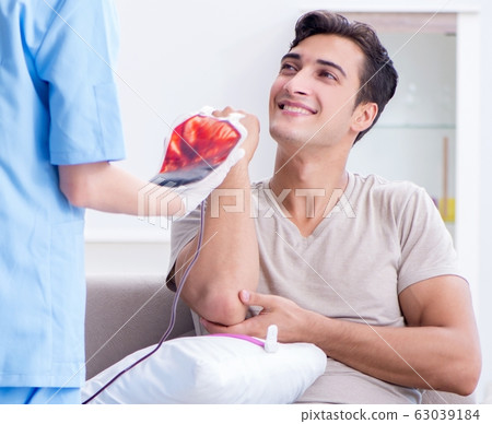 Patient getting blood transfusion in hospital clinic Patient getting blood transfusion in hospital clinic 63039184