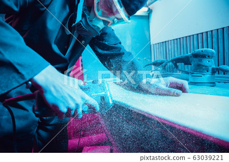 Skater in process of making his own skateboard, longboard - open business concept Skater in process of making his own skateboard, longboard - open business concept 63039221