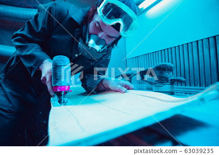 Skater in process of making his own skateboard, longboard - open business concept Skater in process of making his own skateboard, longboard - open business concept 63039235