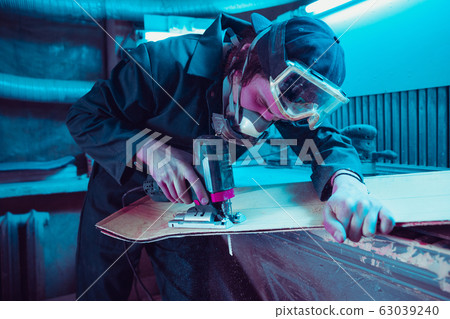 Skater in process of making his own skateboard, longboard - open business concept Skater in process of making his own skateboard, longboard - open business concept 63039240