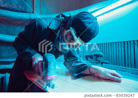 Skater in process of making his own skateboard, longboard - open business concept Skater in process of making his own skateboard, longboard - open business concept 63039247