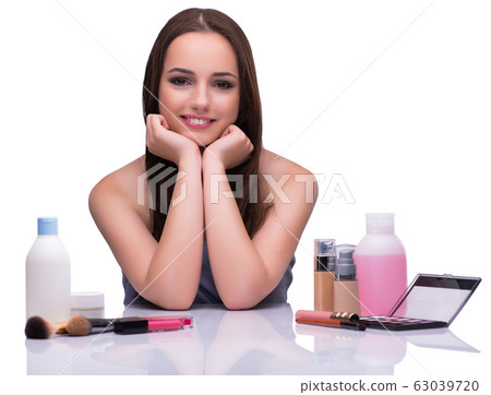 Woman doing makeup isolated on white Woman doing makeup isolated on white 63039720