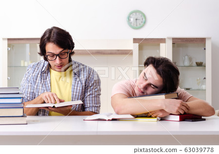 Two male students preparing for exams at home Two male students preparing for exams at home 63039778