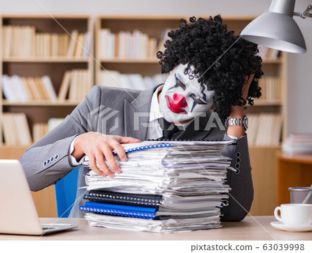 Clown businessman working in the office Clown businessman working in the office 63039998