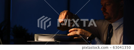 Exhausted male drinking alcoholic drinks Exhausted male drinking alcoholic drinks 63041350