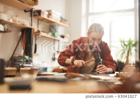 Artisan Using Hammer For Leatherwork Artisan Using Hammer For Leatherwork 63041827